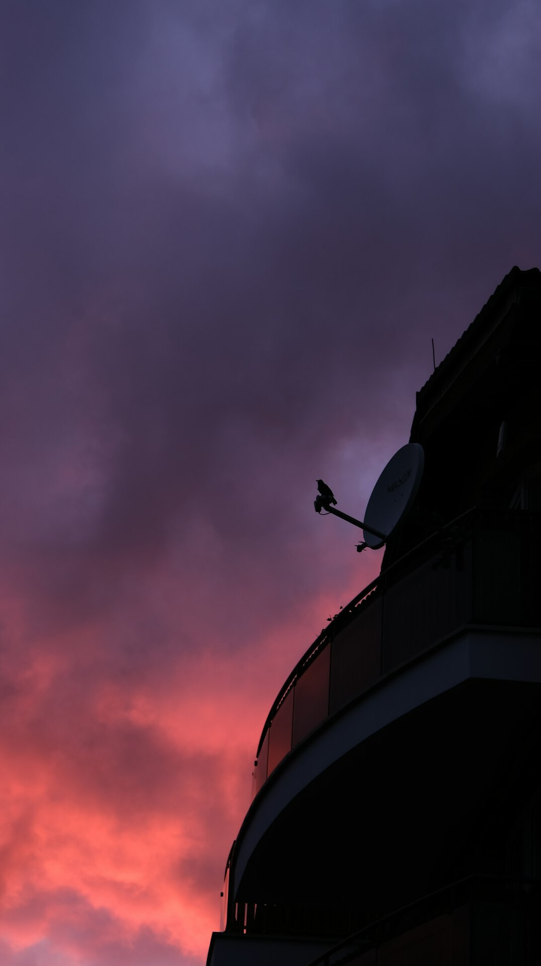 Outside broadcast van with satellite dish at dusk